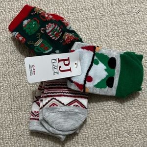 NWT - 3 pairs of socks with grips on bottom.  Size 12-24 months.